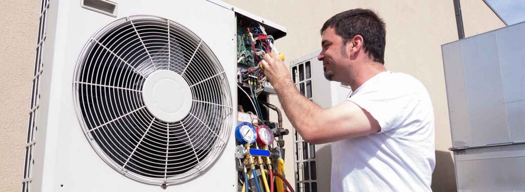Tech repairing an air conditioner.